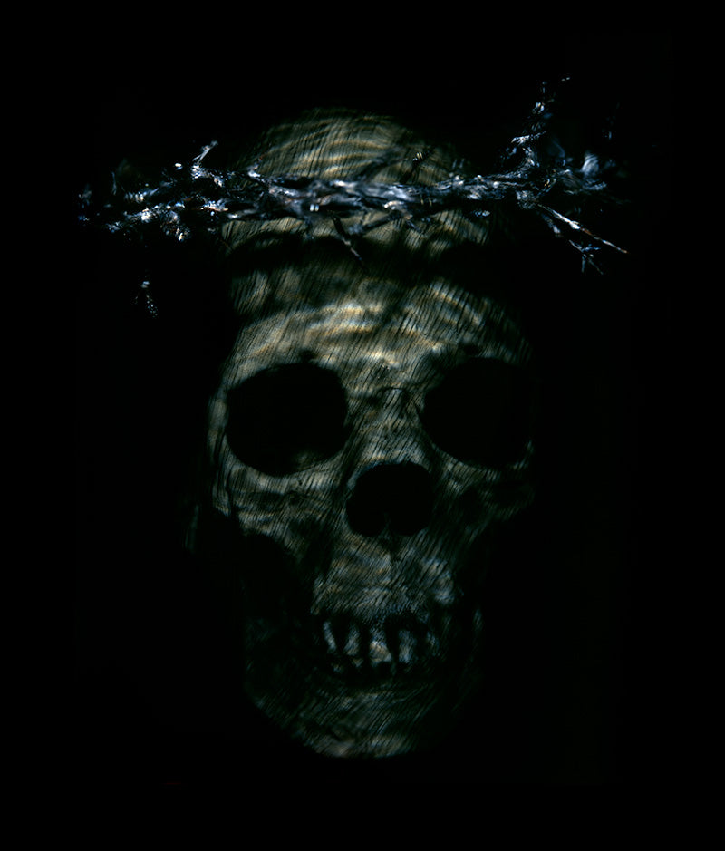 A watery skull crucifixion in a veil with a crown of thorns