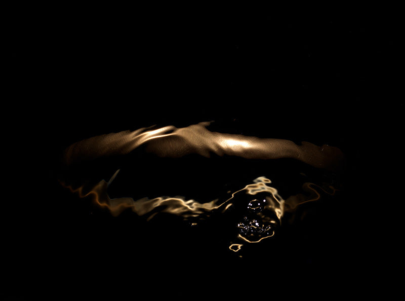 Golden Halo and Light Patterns Underwater As the Gold Form Changes Shape