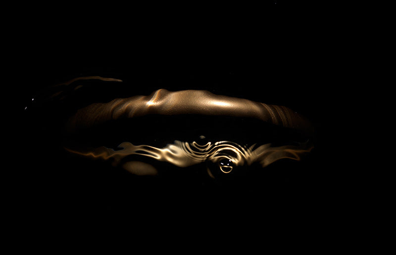 Minimalist Gold Halo in Dark Water As Light Caustics Affect The Shape and form of the piece