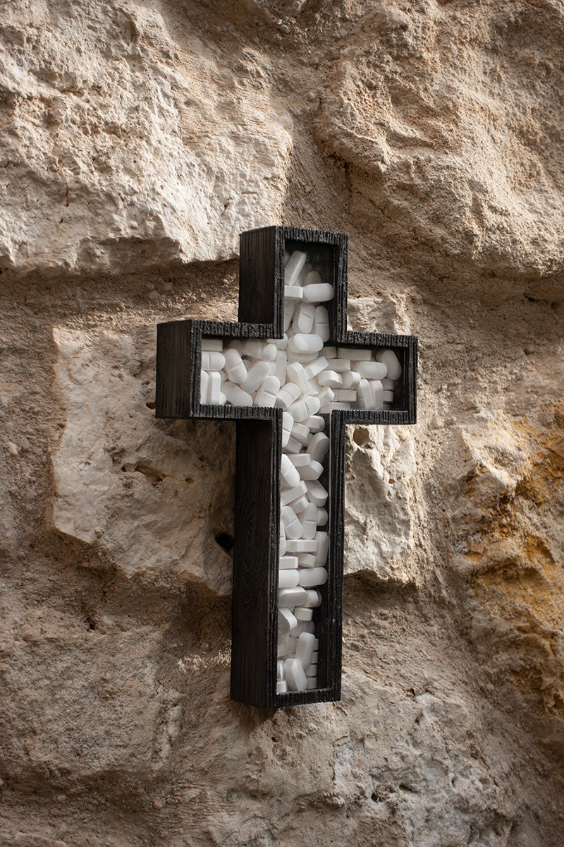 crucifix filled with white pills