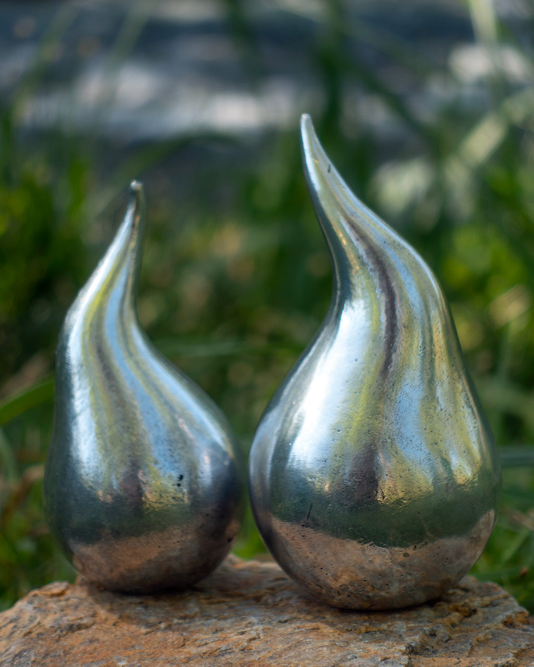 Small and large water droplet aluminium sculptures