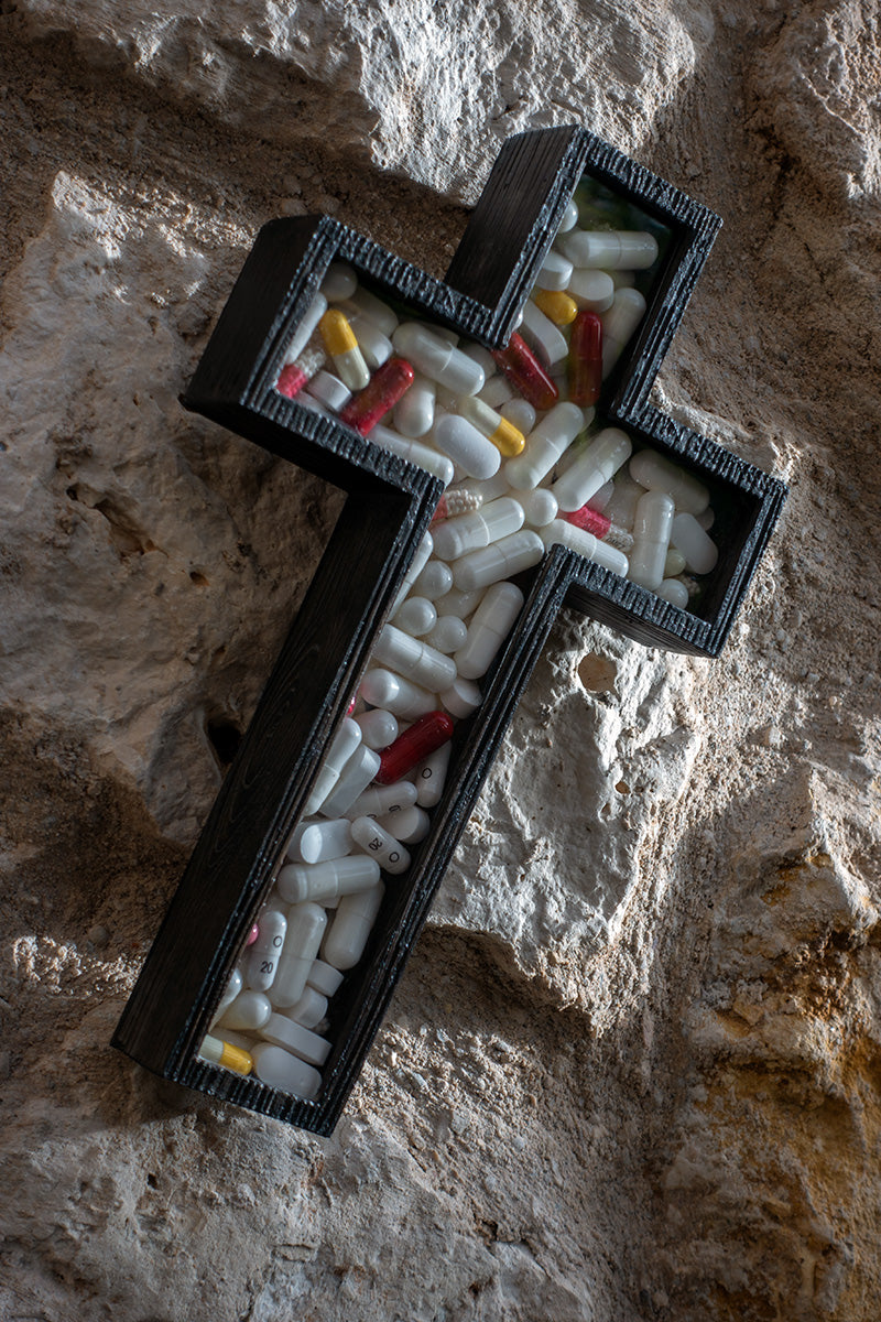 a crucifix filled with pills