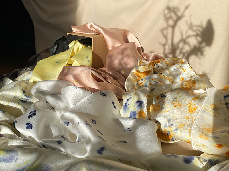 Polka dot silk scarf styled on neck and handbag