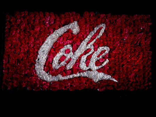 The coke coca cola brand remade in flower petals underwater