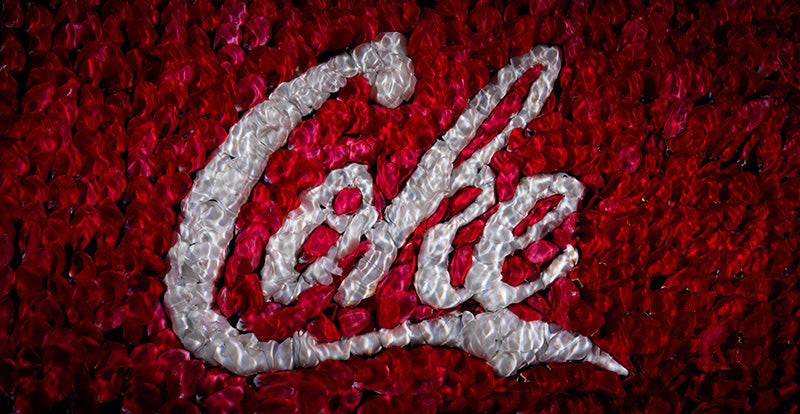 the coke red white brand insignia recreated in flowers