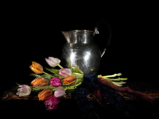 tulips and pewter jug on a wooden table vanitas