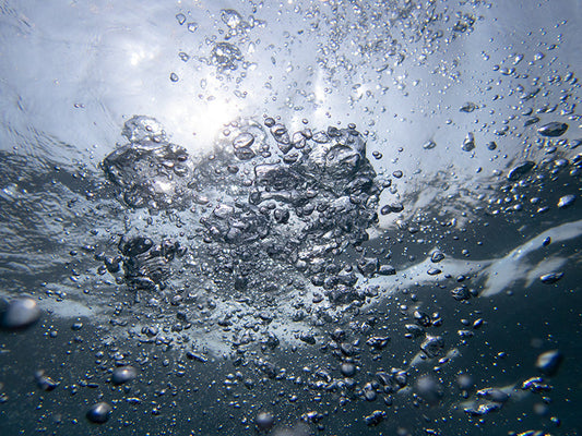 Aqua bubble Spheres Rising in Crystal Clear Water