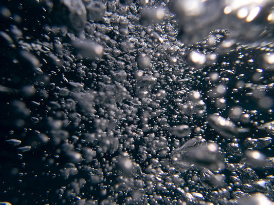 Transparent Bubbles in Sunlit Waters