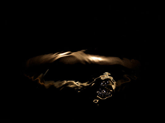 Golden Halo and Light Patterns Underwater As the Gold Form Changes Shape 