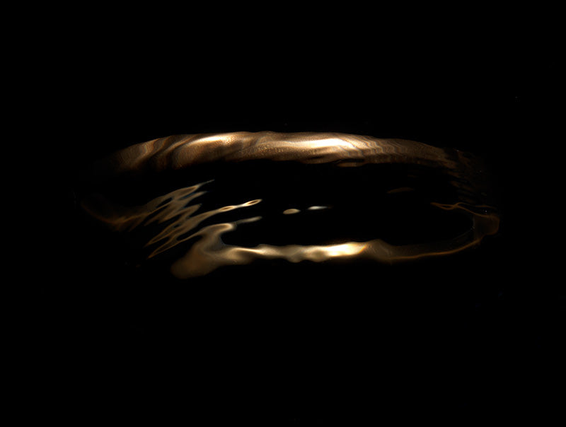 Liquid-Like Gold Halo in Rippling Water shape changing as the water affects the light leaving the scene captured on camera