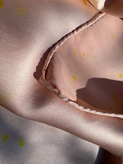 Sustainable fashion scarf with soft sheen and floral motifs