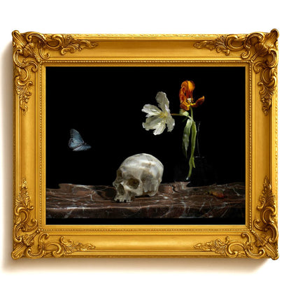 Decorative still life with skull, flowers, and butterfly in a gold frame.