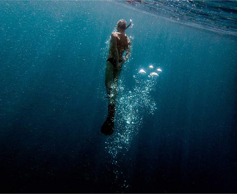 Artist working in an alliance with nature creating interventions of alchemy using oil and water
